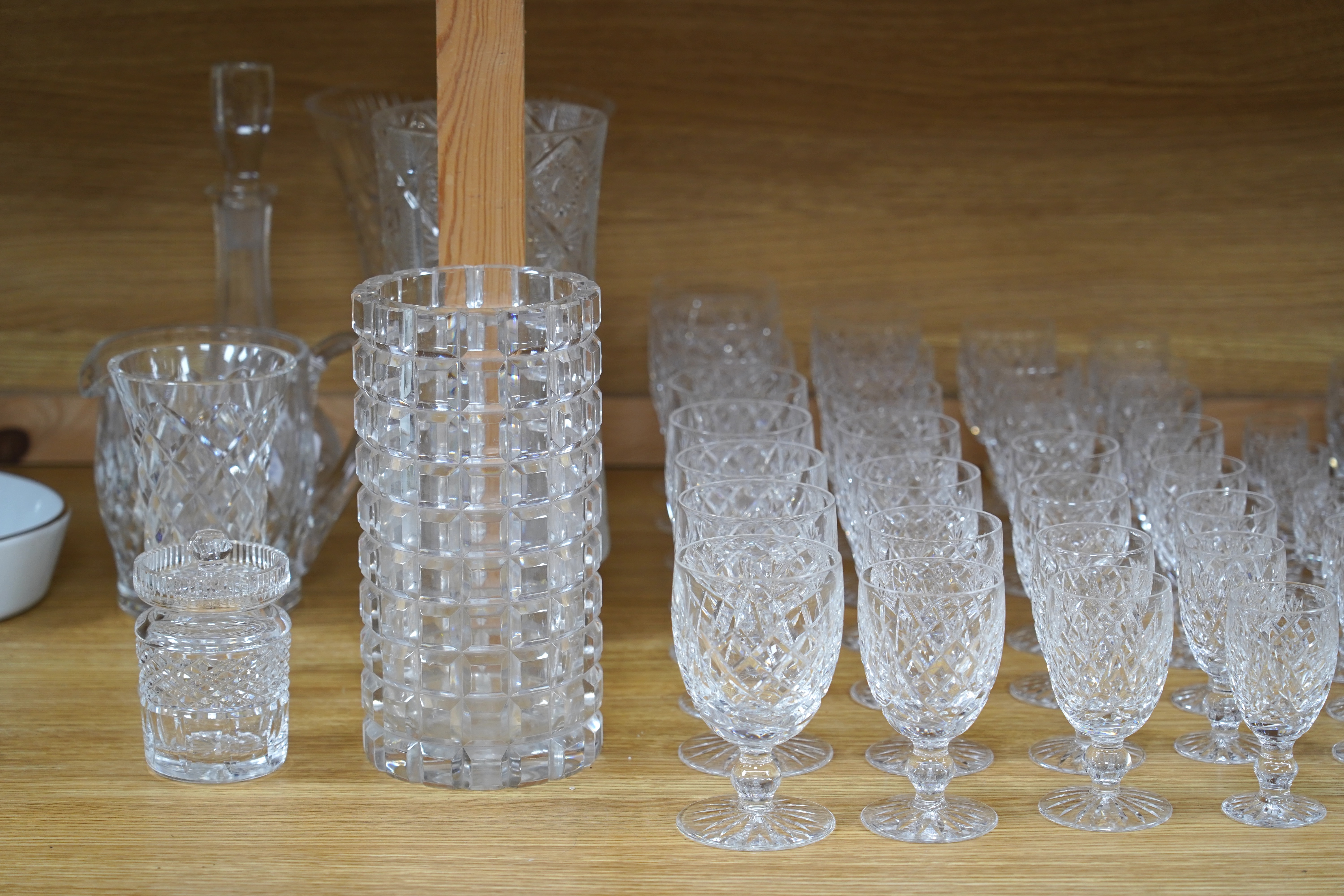 A suite of Waterford drinking glasses in various sizes, including wine glasses, liqueur glasses, champagne glasses, etc. together with glass vases and jugs, etc. (66)